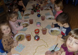 Dzieci z grupy krasnoludków jedzą uroczysty obiad wigilijny.