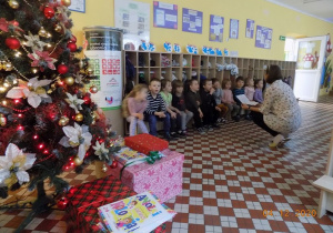 Nauczycielka z grupy muchomorków czyta dzieciom list od Świętego Mikołaja.