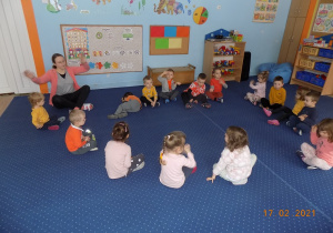 Dzieci pokazują słowa do piosenki o kolorze pomarańczowym