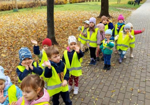 Dzieci spacerują alejką w parku