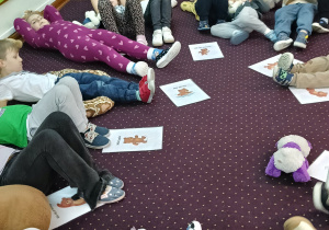 Dzieci odpoczywają po intensywnych ćwiczeniach z misiami