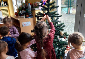 Dzieci ubierają choinkę