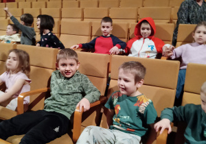 Dzieci siedzą na widowni w Akademii Muzycznej i czekają na koncert.