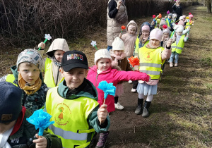 Dzieci idą na spacer w poszukiwaniu wiosny