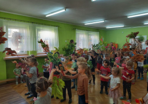 Dzieci tańczą na koncercie edukacyjnym z wykrzystaniem jesiennych liści